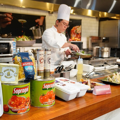 Chef demonstrating recipe application during a client workshop session.