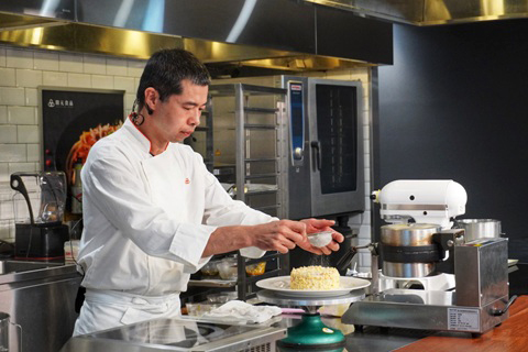 Guest chef demonstrating culinary techniques at Creation Food Innovation Center